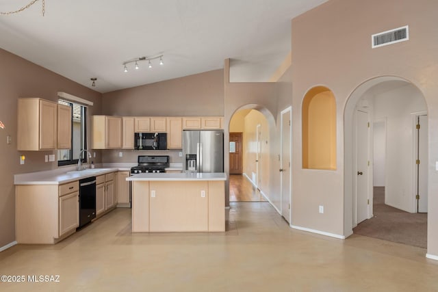 kitchen with black appliances, sink, a towering ceiling, light brown cabinetry, and a kitchen island