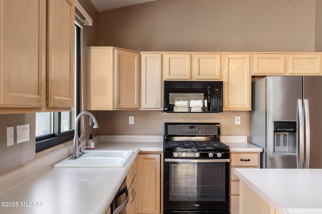 kitchen with light brown cabinetry, sink, and black appliances