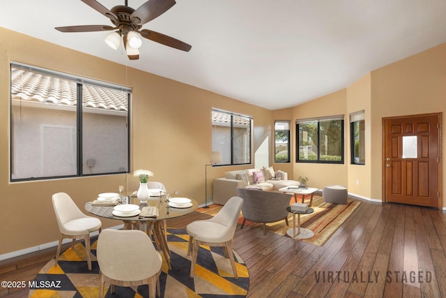 dining space featuring ceiling fan, wood-type flooring, and lofted ceiling