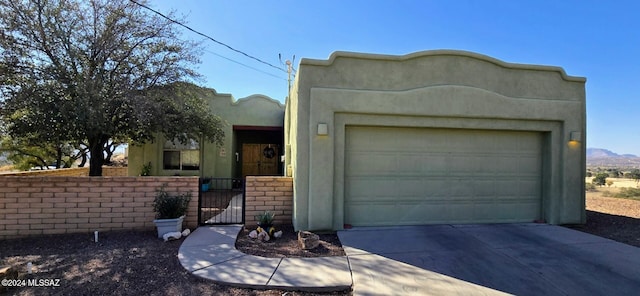 pueblo revival-style home with a garage