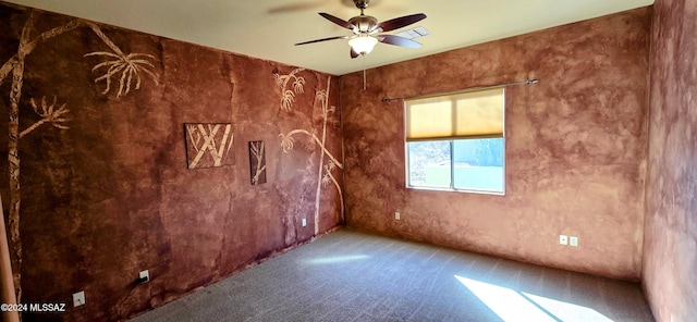 carpeted empty room featuring ceiling fan