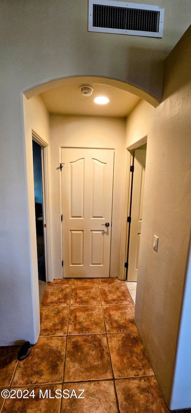 corridor with dark tile patterned flooring