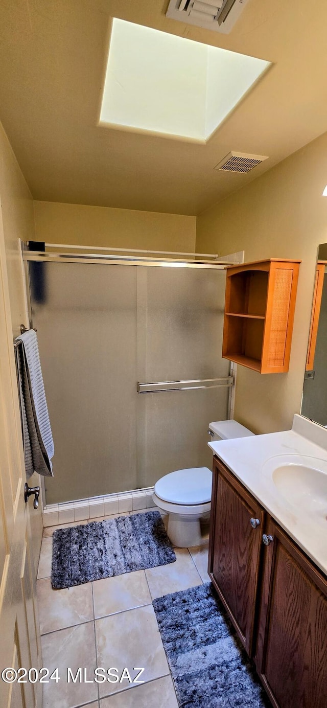 bathroom with tile patterned flooring, vanity, and toilet