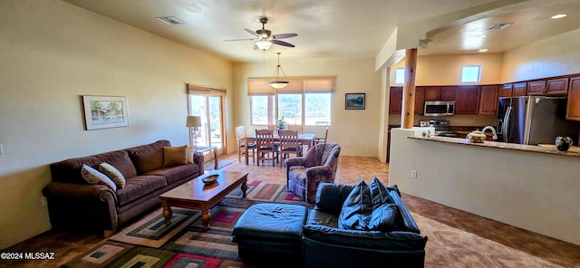 living room with tile patterned floors and ceiling fan