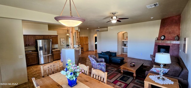 tiled dining area featuring ceiling fan