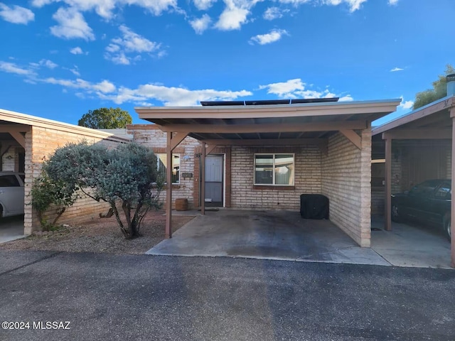 doorway to property with a carport