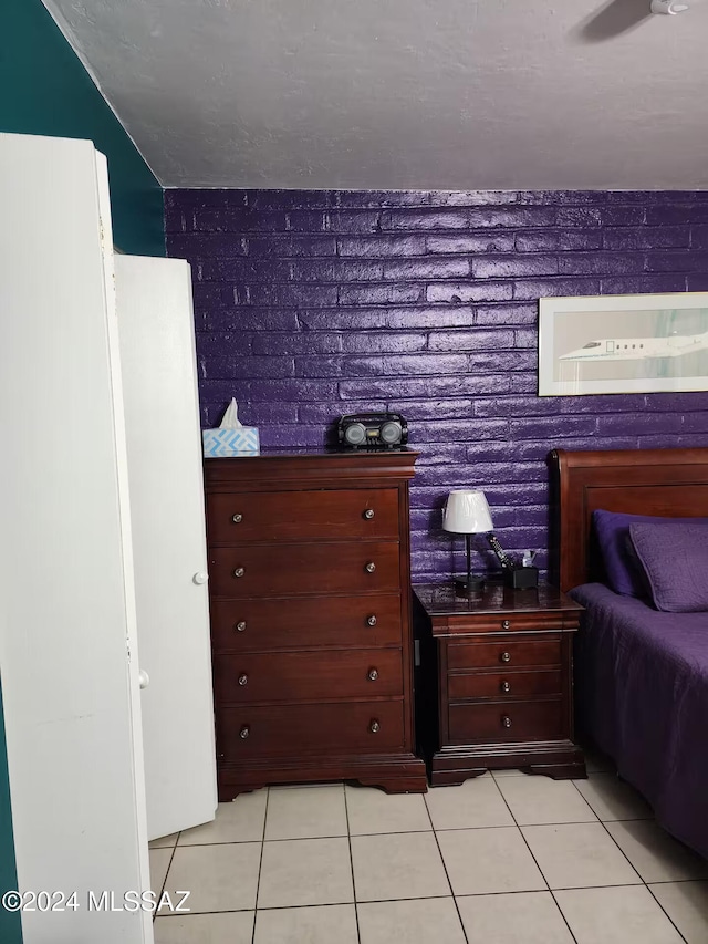 tiled bedroom featuring ceiling fan