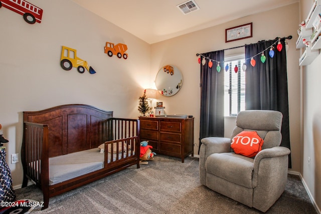 carpeted bedroom featuring a nursery area