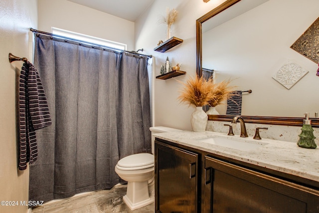 bathroom featuring vanity, toilet, and walk in shower