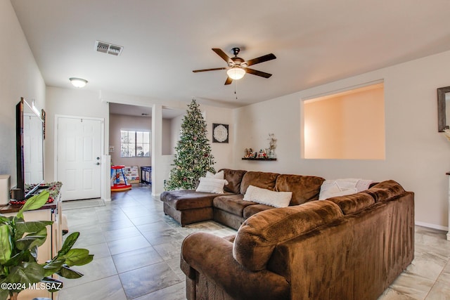 tiled living room with ceiling fan