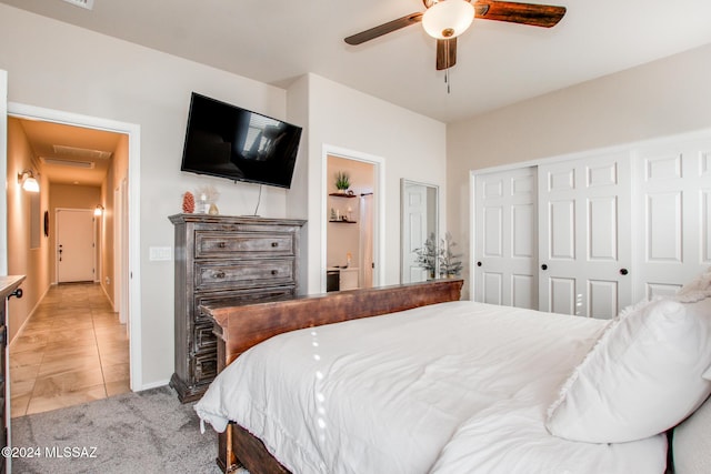 bedroom with light tile patterned floors, a closet, and ceiling fan