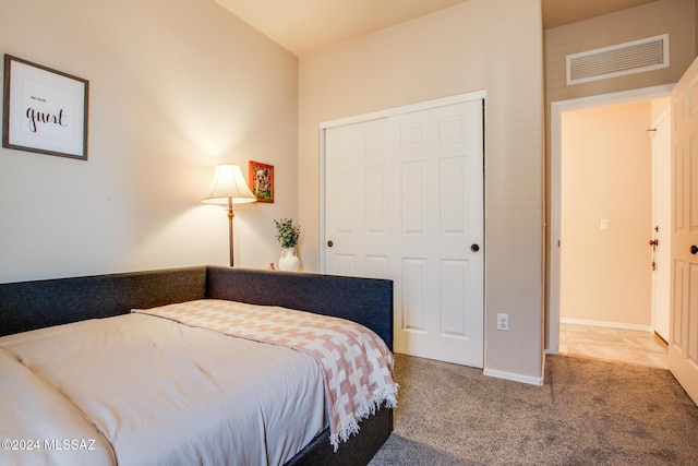 carpeted bedroom with a closet