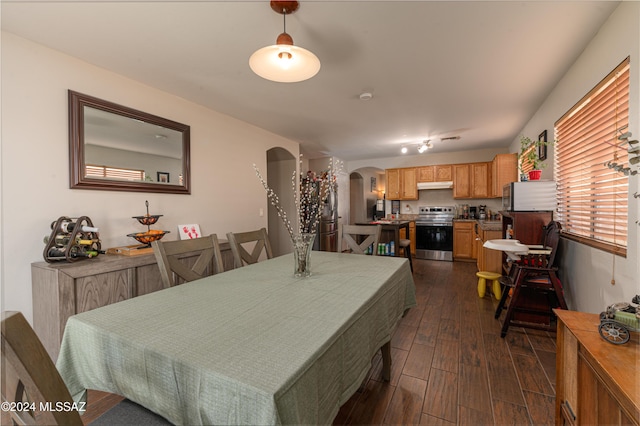 dining space with dark hardwood / wood-style flooring