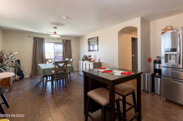 dining area with dark wood-type flooring