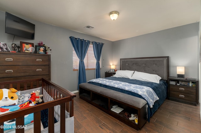 bedroom with dark wood-type flooring