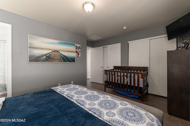 bedroom with dark hardwood / wood-style flooring