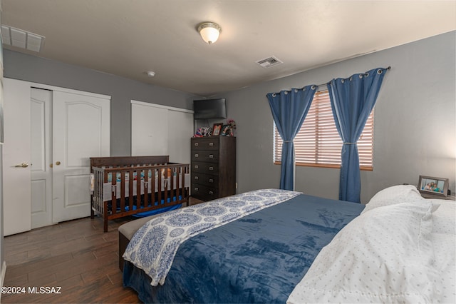 bedroom with dark wood-type flooring