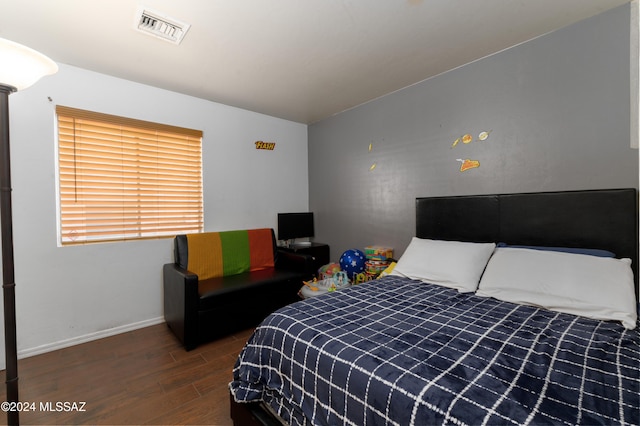 bedroom featuring dark hardwood / wood-style flooring