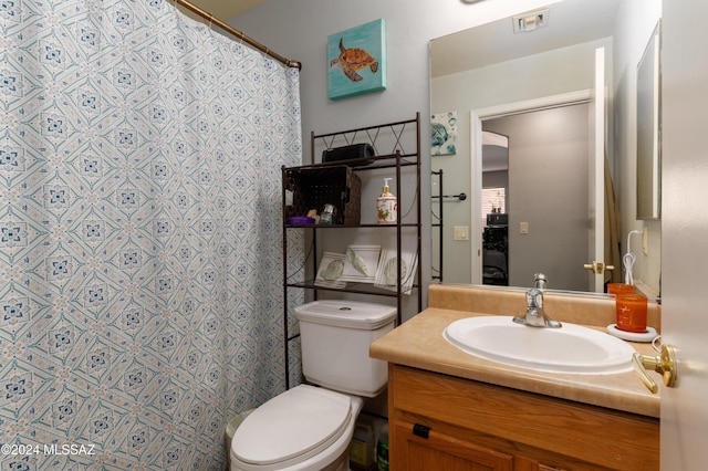 bathroom with a shower with shower curtain, vanity, and toilet