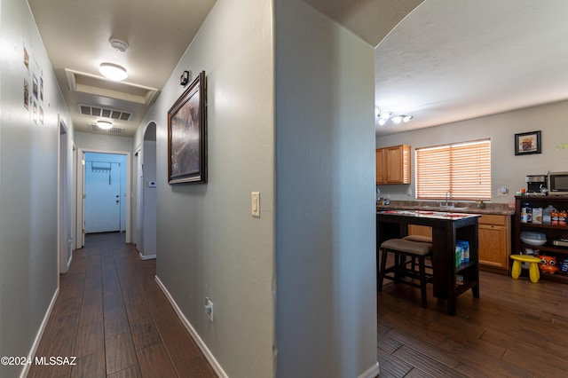 hallway with dark hardwood / wood-style flooring