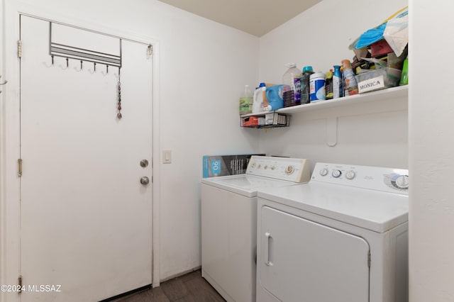 laundry area with separate washer and dryer and dark wood-type flooring