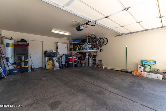 garage featuring a garage door opener and water heater