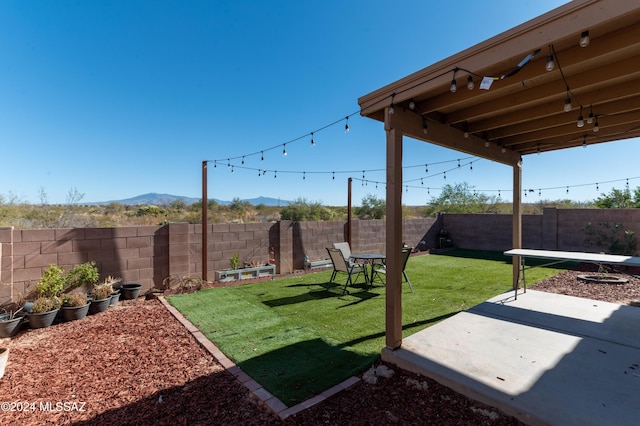 view of yard with a mountain view and a patio