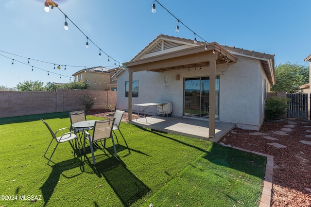 back of house featuring a yard and a patio