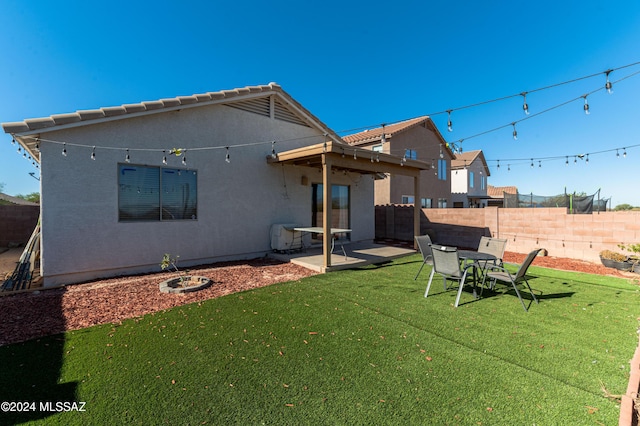 rear view of property with a patio area and a lawn