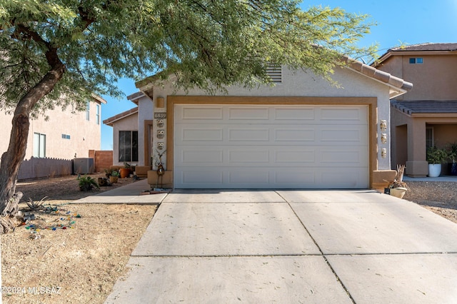 view of front facade featuring central AC and a garage