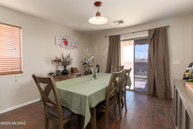 dining space with dark hardwood / wood-style flooring