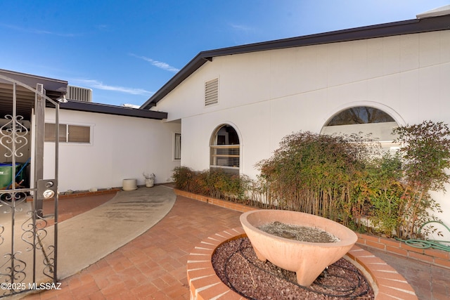 exterior space with a patio area and stucco siding