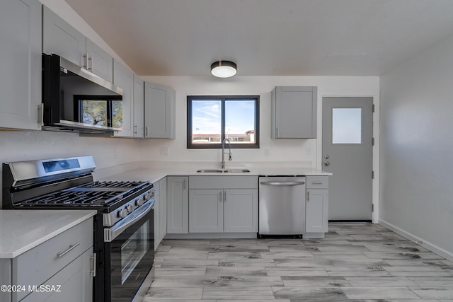 kitchen featuring sink, stainless steel appliances, and light hardwood / wood-style flooring