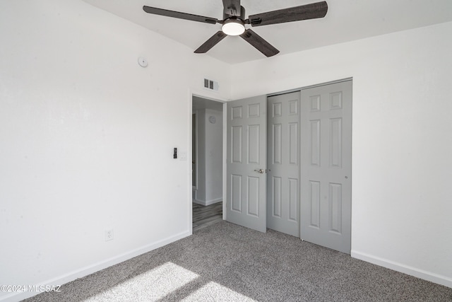 unfurnished bedroom with ceiling fan, a closet, and carpet