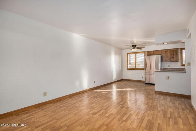 unfurnished living room with ceiling fan and light hardwood / wood-style floors