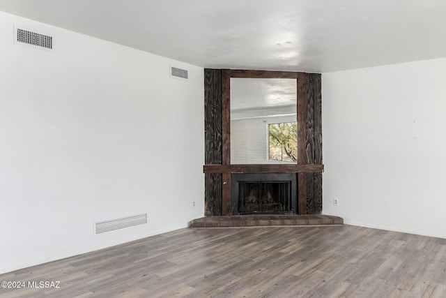 unfurnished living room featuring light wood-type flooring and a fireplace