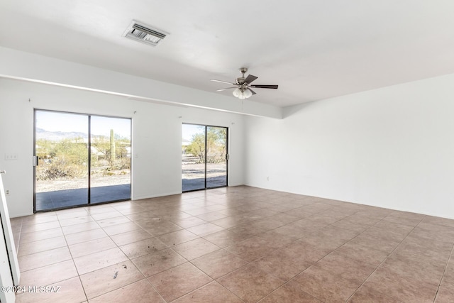 tiled empty room with ceiling fan