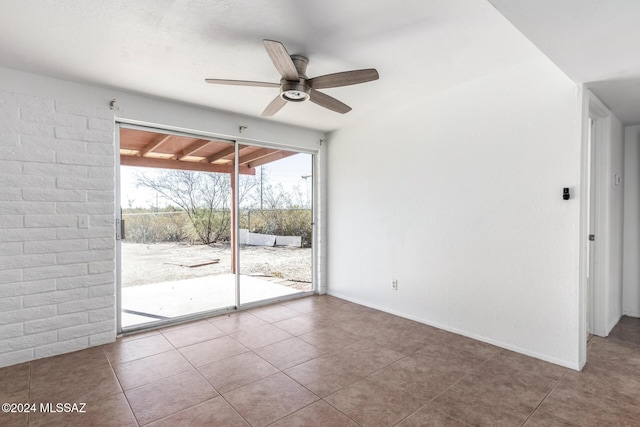 tiled empty room with ceiling fan