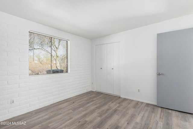 unfurnished bedroom featuring light wood-type flooring and a closet