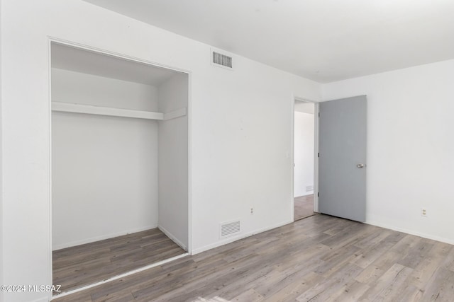 unfurnished bedroom featuring a closet and wood-type flooring