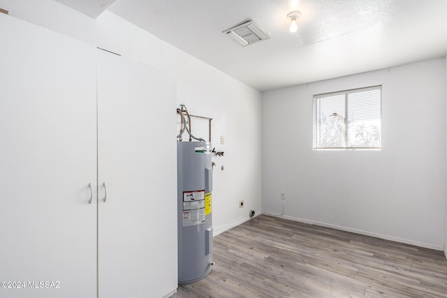 utility room with electric water heater