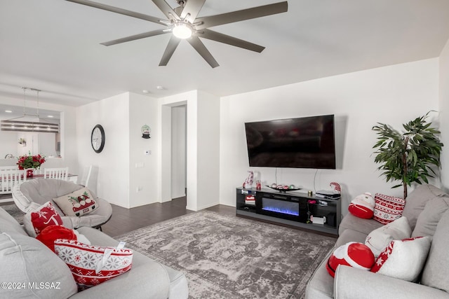 dining space featuring dark hardwood / wood-style floors and ceiling fan with notable chandelier