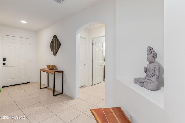 corridor featuring light tile patterned floors