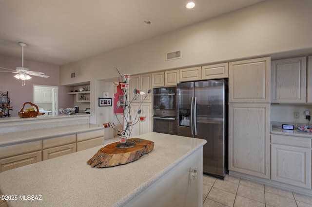 kitchen with ceiling fan, stainless steel fridge, built in shelves, double oven, and light tile patterned flooring