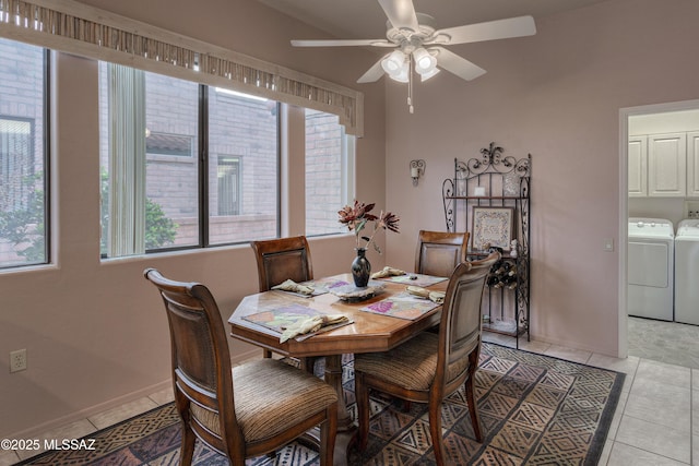 dining space with light tile patterned floors, separate washer and dryer, and ceiling fan