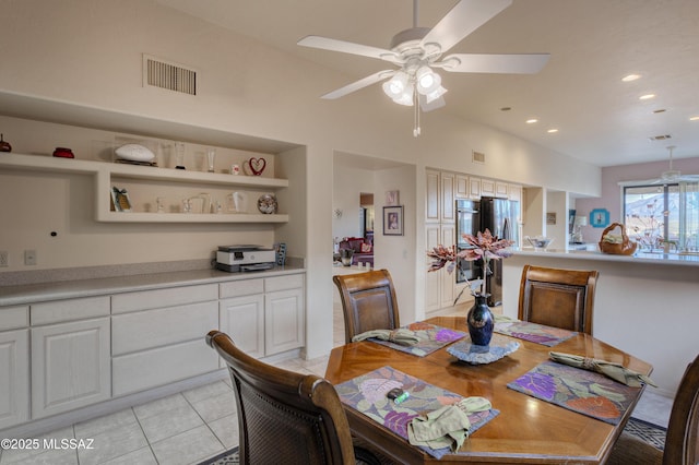 tiled dining room with built in shelves, vaulted ceiling, and ceiling fan