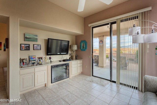 tiled living room with bar area, ceiling fan, and beverage cooler