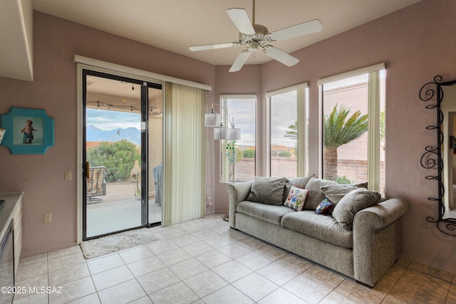 living room featuring light tile patterned floors and ceiling fan