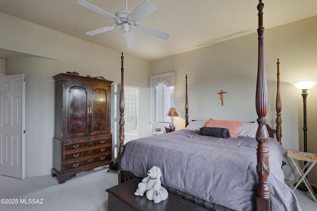 bedroom featuring ceiling fan, light carpet, and ensuite bath