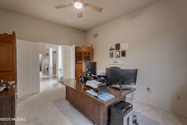 carpeted home office with ceiling fan